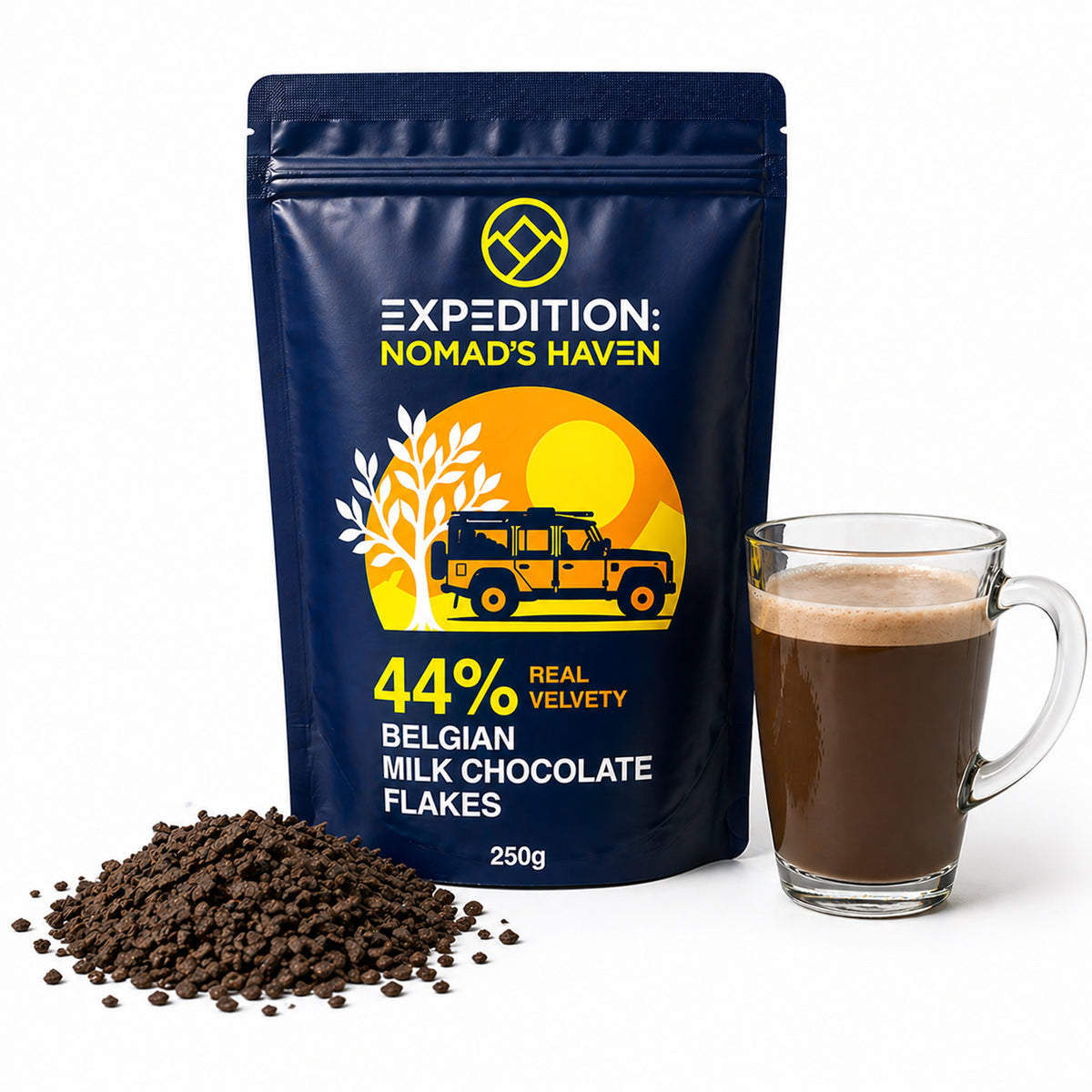 250g pouch of 44% Belgian milk chocolate flakes beside a glass mug of hot chocolate